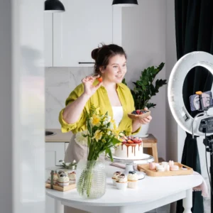A woman creating videos in front of camera and ring light