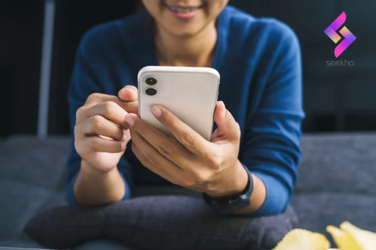 A women with white color smartphone in her hand